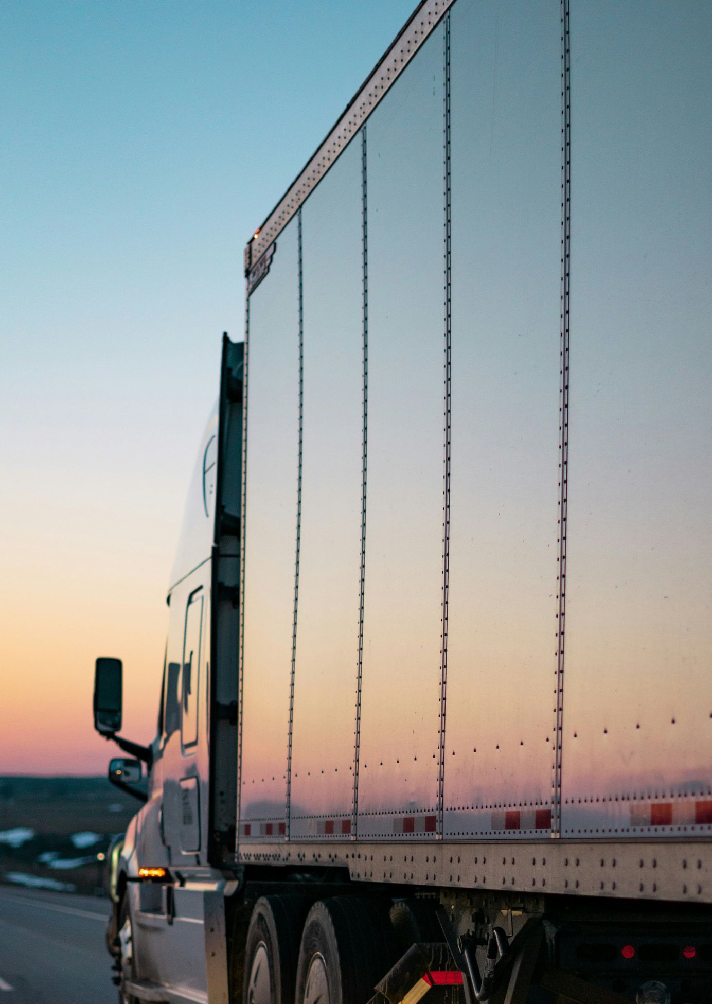 white freight truck on road during daytime